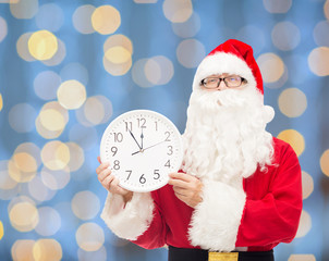 man in costume of santa claus with clock