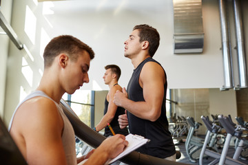 men exercising on treadmill in gym