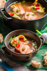 Closeup of fish soup spiced with dill and chilli pepper
