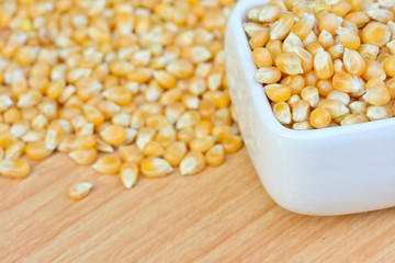 corn seeds in white bowl on table  for food concept