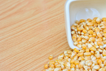 corn seeds in white bowl on table  for food concept