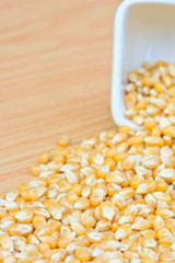 corn seeds in white bowl on table  for food concept