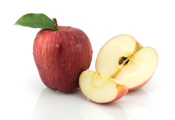 red apples and half of apple on a white background