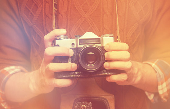 Man holding retro photo camera
