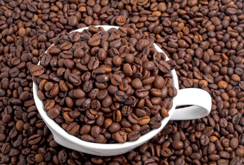 Roasted coffee beans and white cup