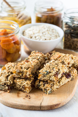 Healthy homemade granola bars and   ingredients  on  background