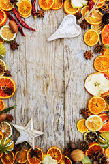 Dried fruits and christmas spices on wooden background