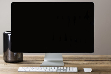 big computer screen with stationary items