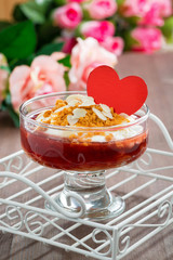 Dessert with jam and whipped cream for Valentine's Day, vertical