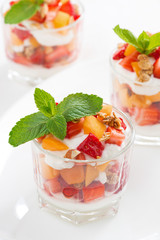 dessert with strawberries, apricots, whipped cream and granola