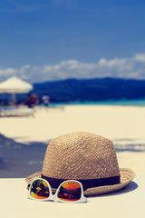 hat and sunglasses on beach vacation