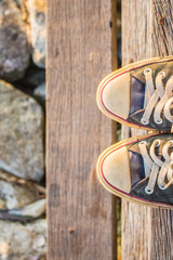 Sneakers on wooden staircase.