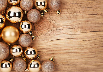 Gold Christmas Balls Over Wooden Background