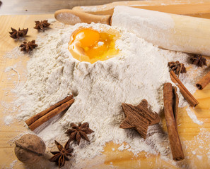 Obraz na płótnie Canvas Baking preparation: eggs, flour, rolling pin, spices on a board