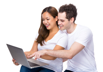 Couple using laptop together