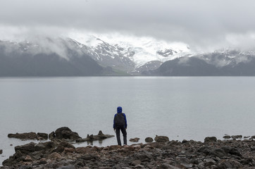 Fototapeta na wymiar Hiker observing mountain lake