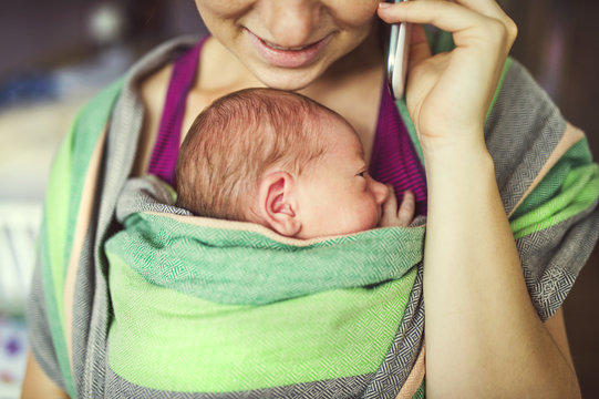 Mother With Baby In The Wrap Carrier