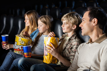 Family Watching Movie In Theater