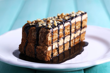 Delicious chocolate cake on plate on table close-up