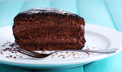 Delicious chocolate cake on plate on table close-up