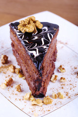 Delicious chocolate cake on plate on table close-up