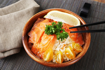 Bowl of boiled rice and fresh salted salmon