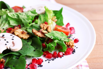 Fresh salad with greens, garnet and spices