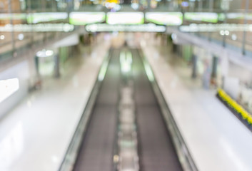 Blurred background of moving escalator in the Airport hall.