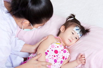 Obraz na płótnie Canvas Sick little girl nursed by a pediatrician