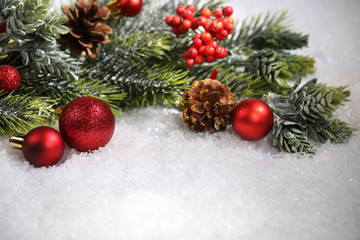 Fototapeta na wymiar Christmas composition with baubles and fir-tree on snow