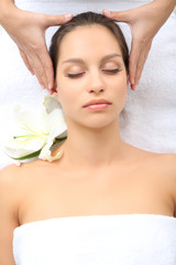 Portrait of beautiful woman taking head massage