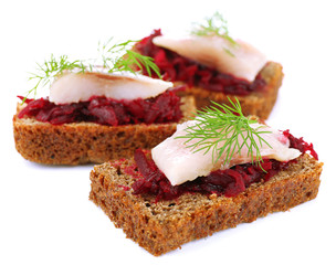 Canape herring with beets on rye toast, isolated on white
