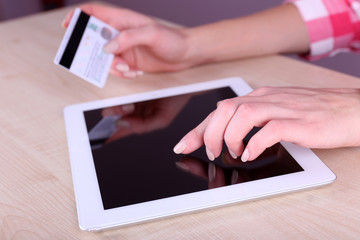 Concept for Internet shopping: hands holding tablet and credit