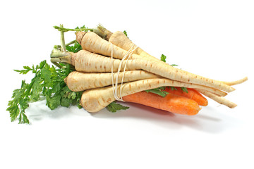 Fresh carrot and parsley with root on white
