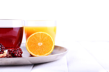 Glasses of fresh orange and pomegranate juice
