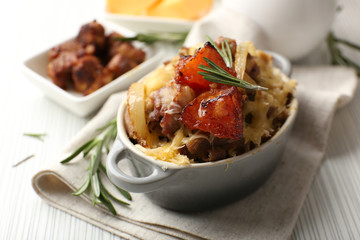 Pasta baked with vegetables and cheese in ceramic pot