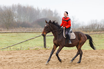 Young woman riding a horse