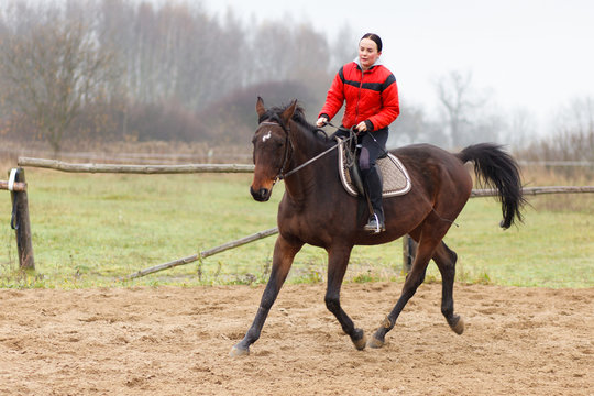 Young woman riding a horse