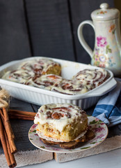 Cinnabon rolls with cinnamon and nuts on a plate