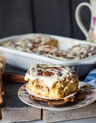 Cinnabon rolls with cinnamon and nuts on a plate