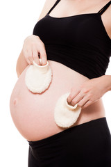 Pregnant woman holding a pair of  baby booties - 73721338