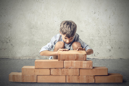 Little boy building a house