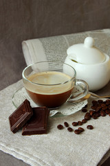 Morning coffee, chocolate and fresh newspaper.
