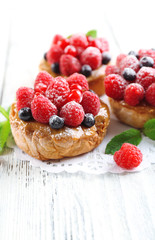 Sweet cakes with berries on table close-up