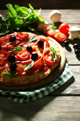 Delicious pizza served on wooden table