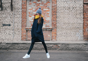 the girl model poses against a brick wall