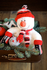 Christmas decorations in old suitcase