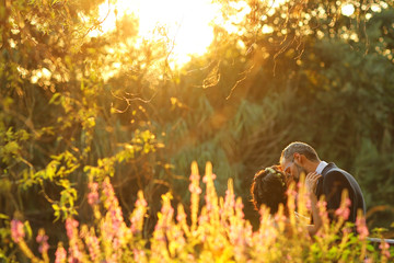 Bride and groom near lake surrounded by nature