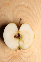 Half apple on wooden background