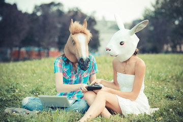 mask horse and rabbit women sisters friends using smartphone and